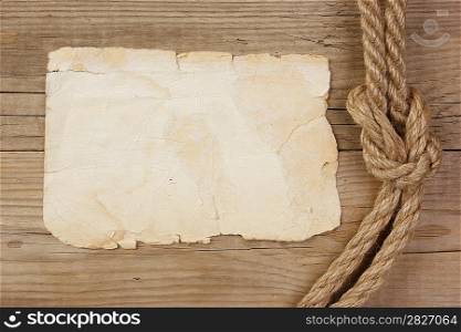 Vintage paper and rope on old wooden boards