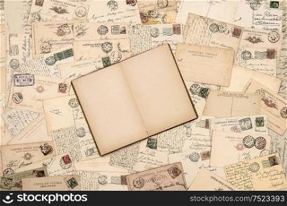Vintage paper background. Old handwritten postcards and open empty book