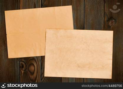 Vintage paper on textured old rustic wooden background