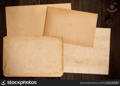 Vintage paper on textured old rustic wooden background