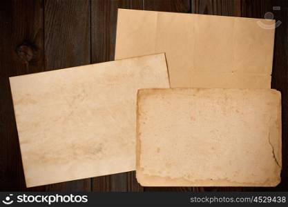 Vintage paper on textured old rustic wooden background