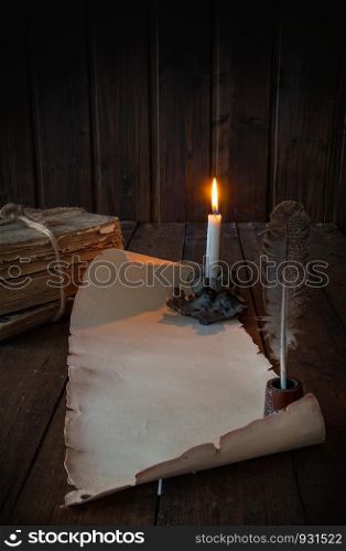 vintage paper scroll on a wooden table a feather for writing by candlelight. scroll on the table