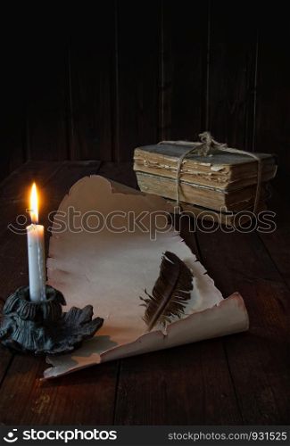 vintage paper scroll on a wooden table a feather for writing by candlelight. scroll on the table
