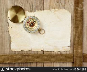 Vintage paper with compass on old wooden boards