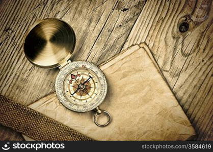 Vintage paper with compass on old wooden boards