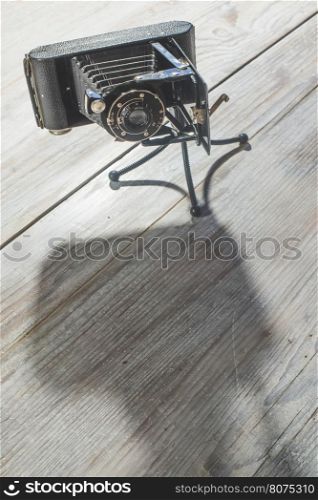 Vintage photo camera on white wooden background. Bulgaria