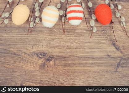 Vintage photo, Easter catkins and eggs wrapped woolen string on rustic board, festive decoration concept, copy space for text. Vintage photo, Easter catkins and eggs wrapped woolen string on rustic board, festive decoration, copy space for text