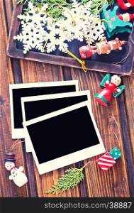 Vintage photo frames decorated for Christmas on the wooden board