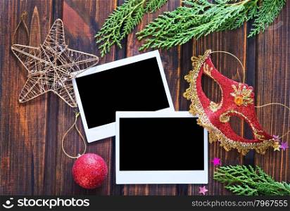 Vintage photo frames decorated for Christmas on the wooden board