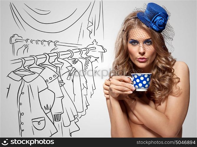 Vintage photo of a beautiful nude girl in a retro hat drinking tea on sketchy background of a dressing room.