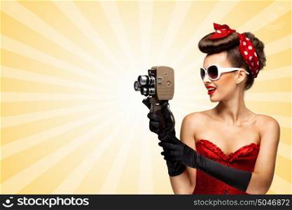 Vintage photo of glamorous pinup girl wearing a red sexy corset, filming with an old retro cinema 8 mm camera on colorful abstract cartoon style background.