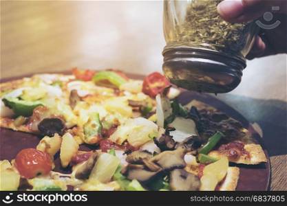 Vintage photo of pizza with colorful vegetable topping ready to be eaten