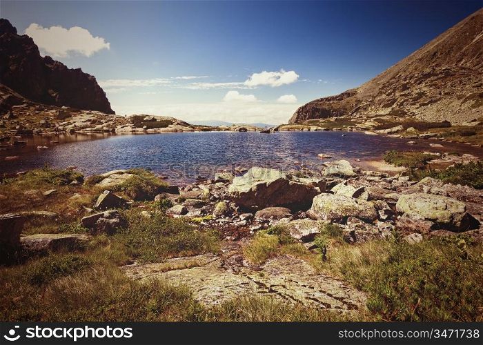 Vintage photo of summer alpine mountain lake