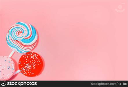 Vintage pink background with three varicolored candy. Space for copy.. Vintage Pink Background With Colored Candy