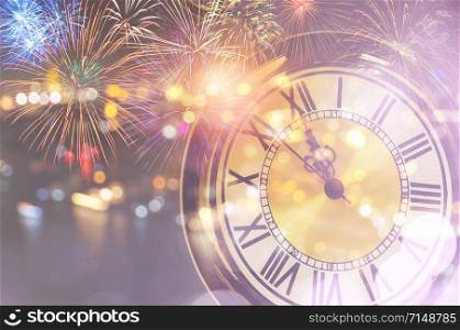 Vintage pocket watch with bokeh lights and colorful fireworks. New year at midnight celebration concept