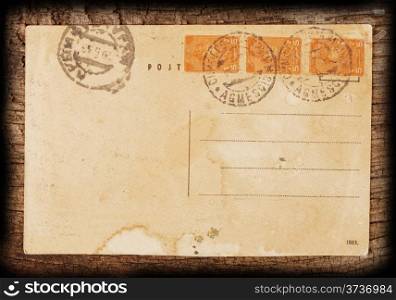 Vintage postcard on the rough wooden background