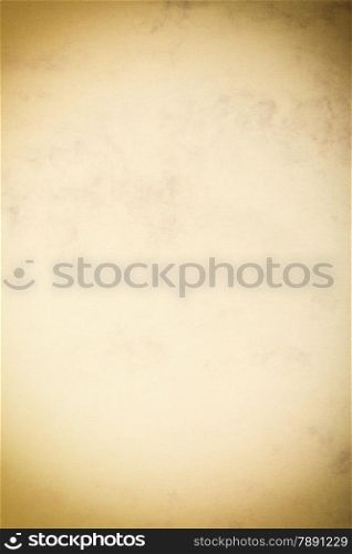 Vintage poster paper texture with a glowing center and grunge vignette abstract background