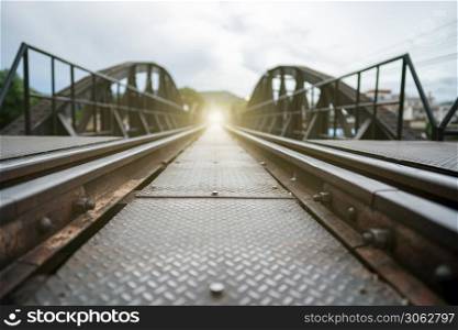 Vintage railroad, railway tracks in a rural scene with golden light at the end destination.