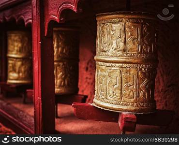 Vintage retro effect filtered hipster style image of Buddhist prayer wheels in Thiksey gompa (Tibetan buddhist monstery). Ladakh, India. Buddhist prayer wheels , Ladakh