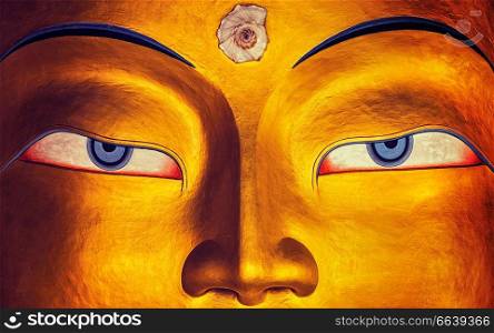 Vintage retro effect filtered hipster style image of eyes of Maitreya Buddha face close up. Thiksey Gompa. Ladakh, India. Maitreya Buddha face close up, Thiksey Gompa, Ladakh