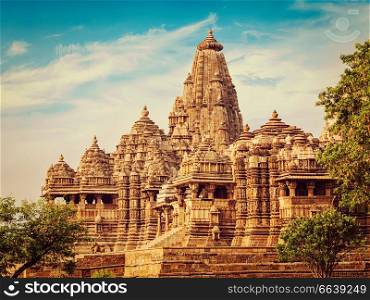 Vintage retro effect filtered hipster style image of famous indian Madhya Pradesh tourist landmark - Kandariya Mahadev Temple, Khajuraho, India. Unesco World Heritage Site. Kjaruharo temples, India