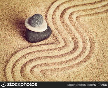 Vintage retro effect filtered hipster style image of Japanese Zen stone garden - relaxation, meditation, simplicity and balance concept - pebbles and raked sand tranquil calm scene