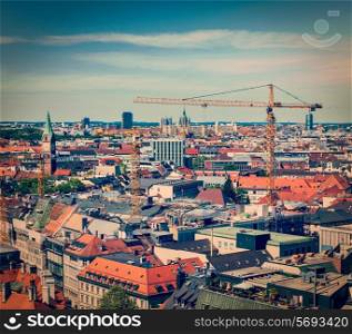 Vintage retro effect filtered hipster style travel image of aerial view of Munich with construction site and cranes, Bavaria, Germany