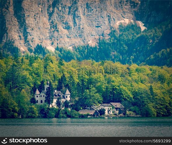 Vintage retro effect filtered hipster style travel image of castle at Hallstatter See mountain lake in Austria. Salzkammergut region, Austria
