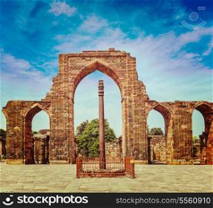 Vintage retro effect filtered hipster style travel image of Iron pillar in Qutub complex - metallurgical curiosity. Qutub Complex, Delhi, India