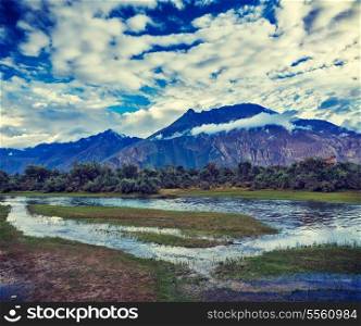 Vintage retro effect filtered hipster style travel image of Panorama of Himalayas and landscape of Nubra valley on sunset. Hunber, Nubra valley, Ladakh, India