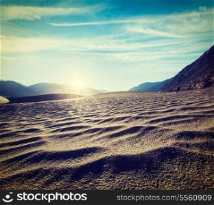 Vintage retro effect filtered hipster style travel image of Sand dunes in Himalayas on sunrise. Hunder, Nubra valley, Ladakh, India