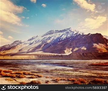 Vintage retro effect filtered hipster style travel image of Spiti Valley - snowcapped Himalayan Mountains. Himachal Pradesh, India