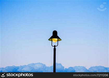 Vintage retro electric light pole with blue evening sky background with copy space on both side for design work