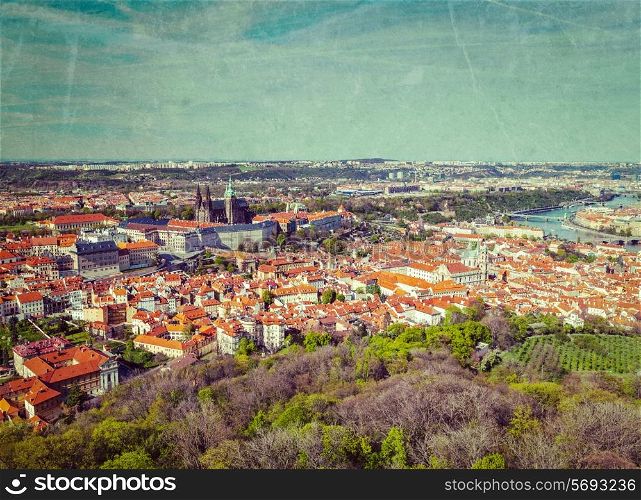 Vintage retro hipster style image of aerial view of Hradchany the Saint Vitus Cathedral and Prague Castle from Petrin Observation Tower with grunge texture overlaid. Prague, Czech Republic