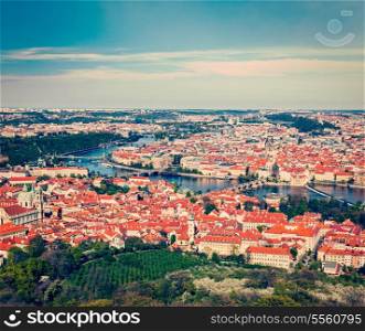 Vintage retro hipster style travel image of aerial view of Charles Bridge over Vltava river and Old city from Petrin hill Observation Tower. Prague, Czech Republic