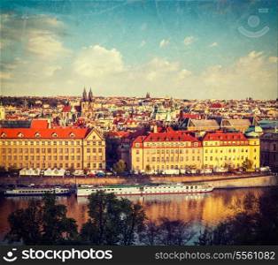 Vintage retro hipster style travel image of aerial view of Prague and Vltava river on sunset, Czech Republic with grunge texture overlaid