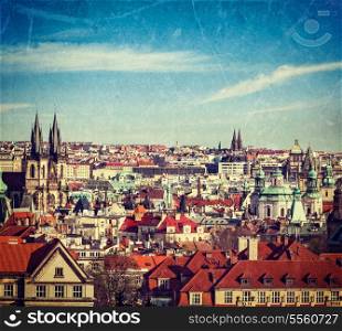 Vintage retro hipster style travel image of aerial view of Prague, Czech Republic with grunge texture overlaid