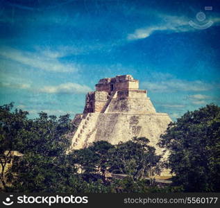Vintage retro hipster style travel image of anicent mayan pyramid (Pyramid of the Magician, Adivino) in Uxmal, Merida, YucatA?n, Mexico with grunge texture overlaid
