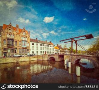 Vintage retro hipster style travel image of canal with old bridge. Bruges (Brugge), Belgium with grunge texture overlaid