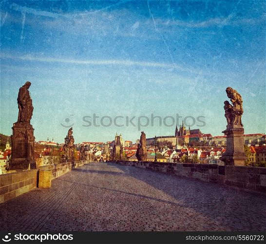 Vintage retro hipster style travel image of Charles bridge and Prague castle in the early morning with grunge texture overlaid. Prague, Czech Republic