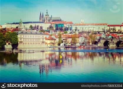 Vintage retro hipster style travel image of Charles bridge over Vltava river and Gradchany Prague Castle and St. Vitus Cathedral