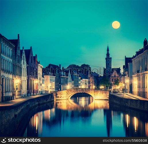 Vintage retro hipster style travel image of European medieval night city view background - Bruges (Brugge) canal in the evening, Belgium