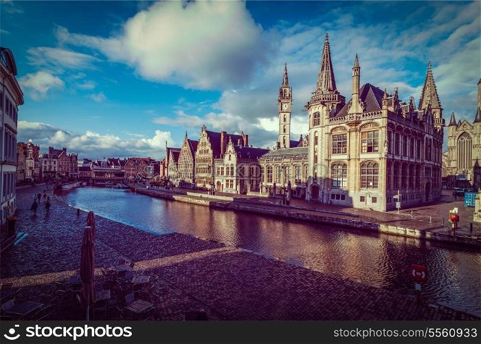 Vintage retro hipster style travel image of Ghent canal and Graslei street on sunset. Ghent, Belgium