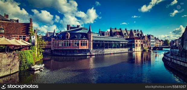 Vintage retro hipster style travel image of Ghent canal and medieval building panorama. Ghent, Belgium