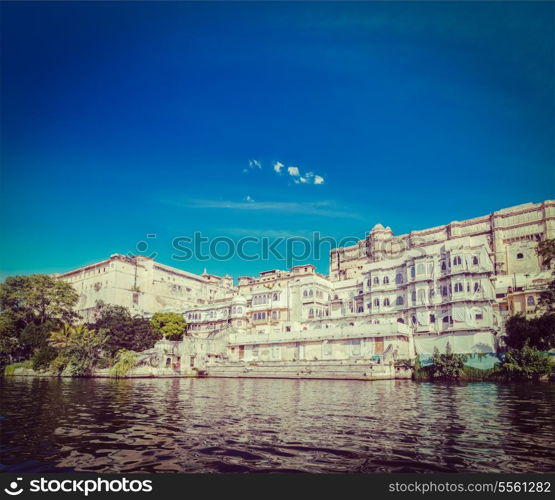 Vintage retro hipster style travel image of India luxury tourism concept background - Udaipur City Palace from Lake Pichola. Udaipur, Rajasthan, India