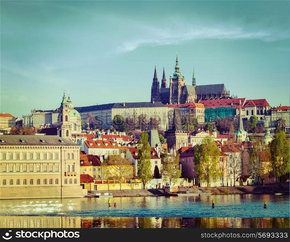 Vintage retro hipster style travel image of Mala Strana and Prague castle over Vltava river. Prague, Czech Republic