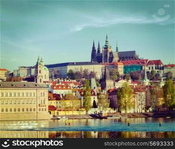 Vintage retro hipster style travel image of Mala Strana and Prague castle over Vltava river. Prague, Czech Republic