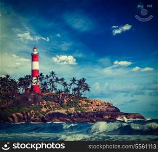 Vintage retro hipster style travel image of old lighthouse and waves of sea. Kovalam (Vizhinjam) Kerala, India