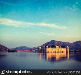 Vintage retro hipster style travel image of Rajasthan landmark - Jal Mahal (Water Palace) on Man Sagar Lake on sunset with grunge texture overlaid. Jaipur, Rajasthan, India