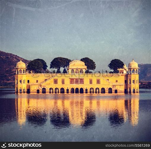 Vintage retro hipster style travel image of Rajasthan landmark - Jal Mahal (Water Palace) on Man Sagar Lake on sunset. Jaipur, Rajasthan, India with grunge texture overlaid